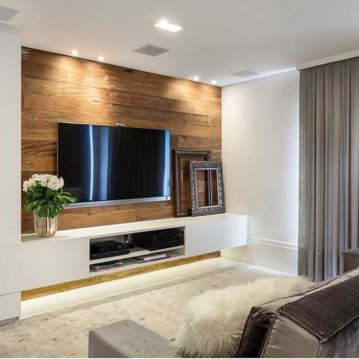 На какой высоте вешать телевизор на стену в гостиной: монтаж и оформление